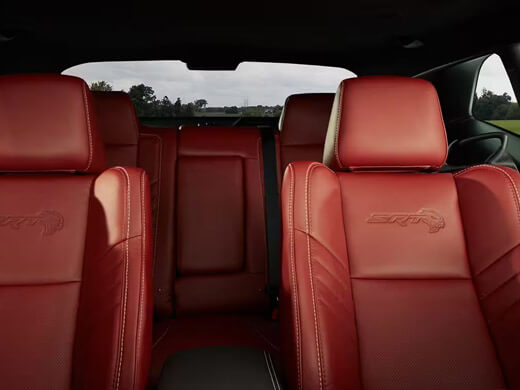 The Demonic Red Laguna leather-trimmed seats with SRT Hellcat logo in the 2023 Dodge Challenger SRT Hellcat Redeye Widebody.