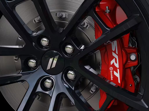 A close-up of the wheel and red brembo brake caliper on the 2023 Dodge Challenger SRT.