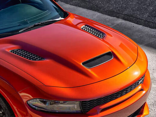 A raised angle of the hood on an orange 2023 Dodge Charger SRT Hellcat.